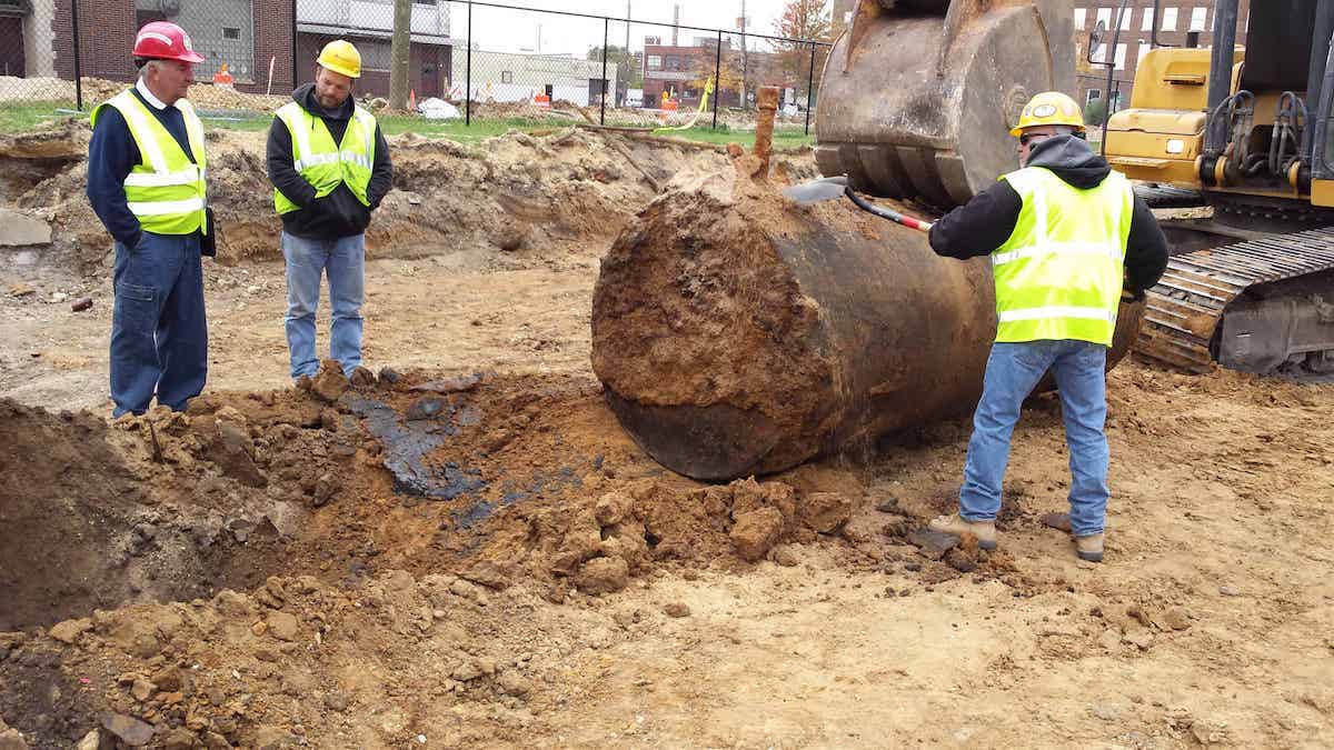 Removing excavated underground storage tanks.